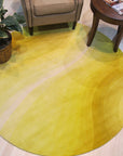 Inviting Ruby Yellow Hand Tufted Wool Rug, a vibrant burst of ruby yellow and cream tones in a hand-tufted wool rug, warmly anchors a modern living space with light wood flooring.