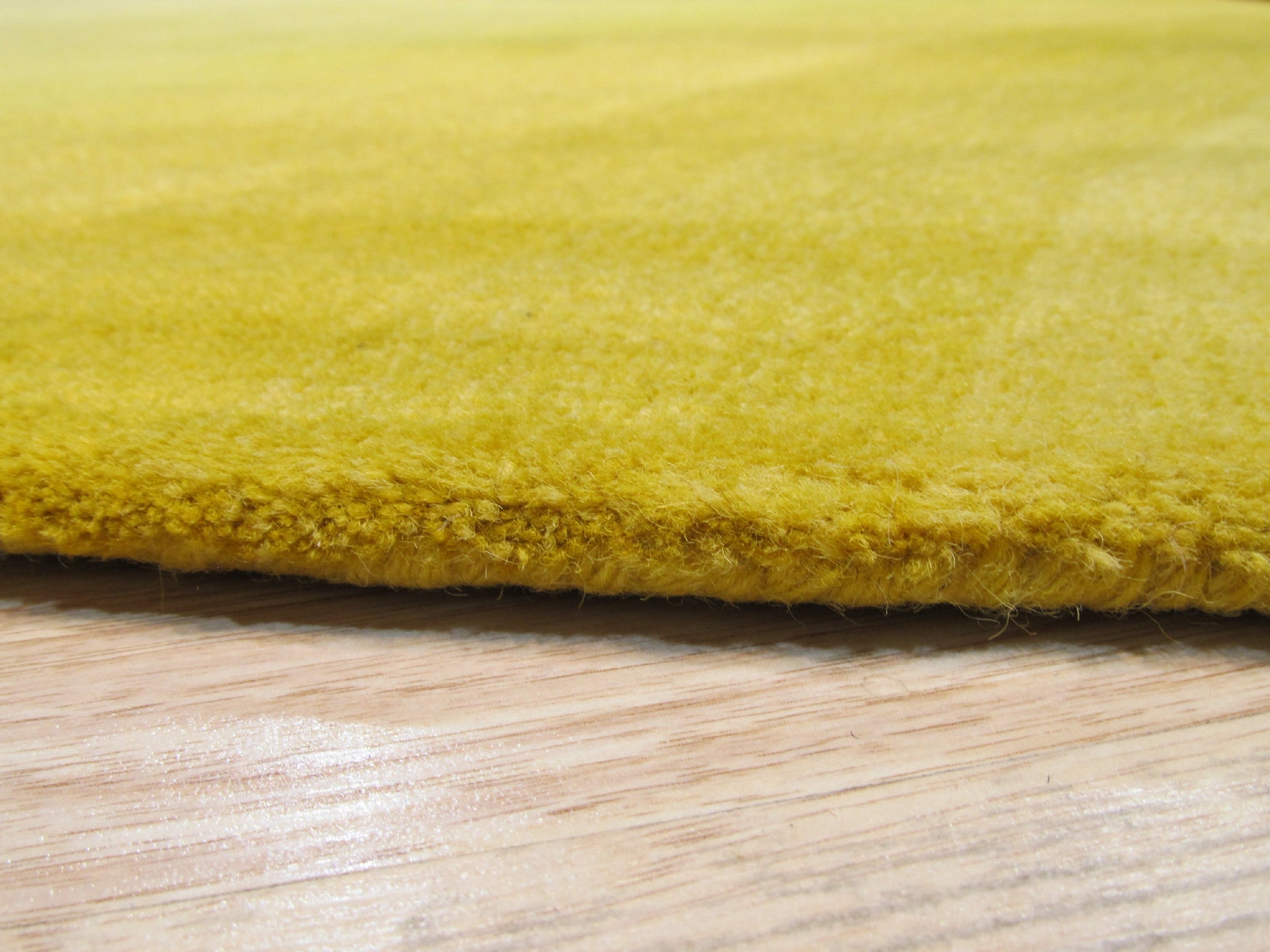 Inviting Ruby Yellow Hand Tufted Wool Rug, vibrant yellow and ruby accents swirl in a hand-tufted wool rug, lending warmth and texture to a modern living space.