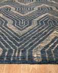 Lila Dahlia Blue Hand Tufted Wool Rug, its dahlia-inspired floral design blooming in shades of blue across a soft, hand-tufted wool canvas.
