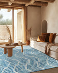 Lila Dahlia Blue Hand Tufted Wool Rug, soft blue wool rug featuring a dahlia-inspired floral pattern, adds a touch of elegance to a bright living space.