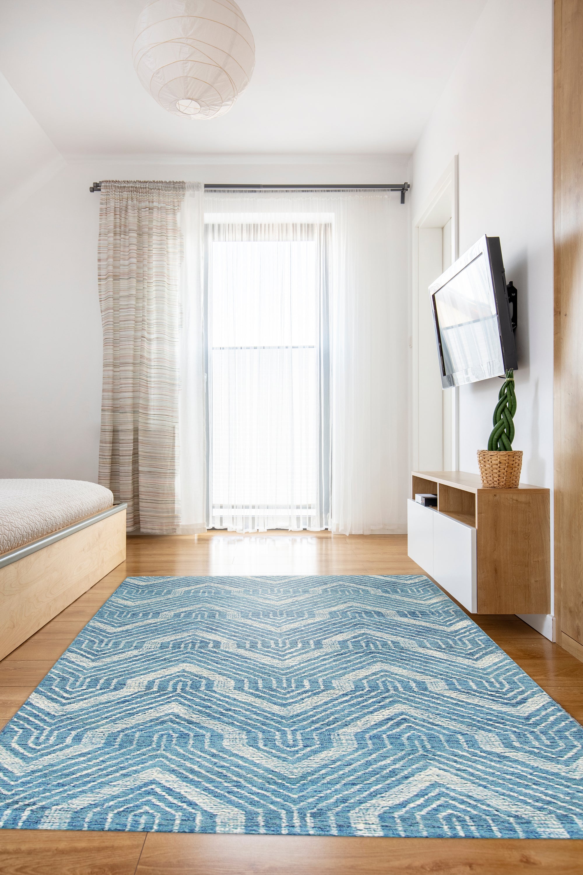 Lila Dahlia Blue Hand Tufted Wool Rug, intricate floral patterns swirl across a field of calming blue, hand-tufted wool offering luxurious texture and vibrant color.