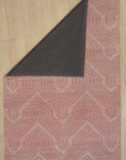 Maya Lush Pink Hand Tufted Wool Rug, a soft and textured wool rug in a vibrant blush pink, lies flat on a light surface. Its hand-tufted construction creates a plush pile, inviting touch and adding a warm accent.