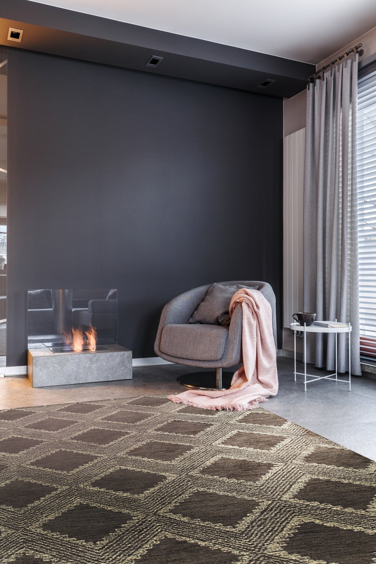 Xena Ava Charcoal Hand Tufted Wool Rug displayed in a room setting, its textured charcoal wool providing a grounding element to the space.