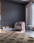 Xena Ava Charcoal Hand Tufted Wool Rug displayed in a room setting, its textured charcoal wool providing a grounding element to the space.