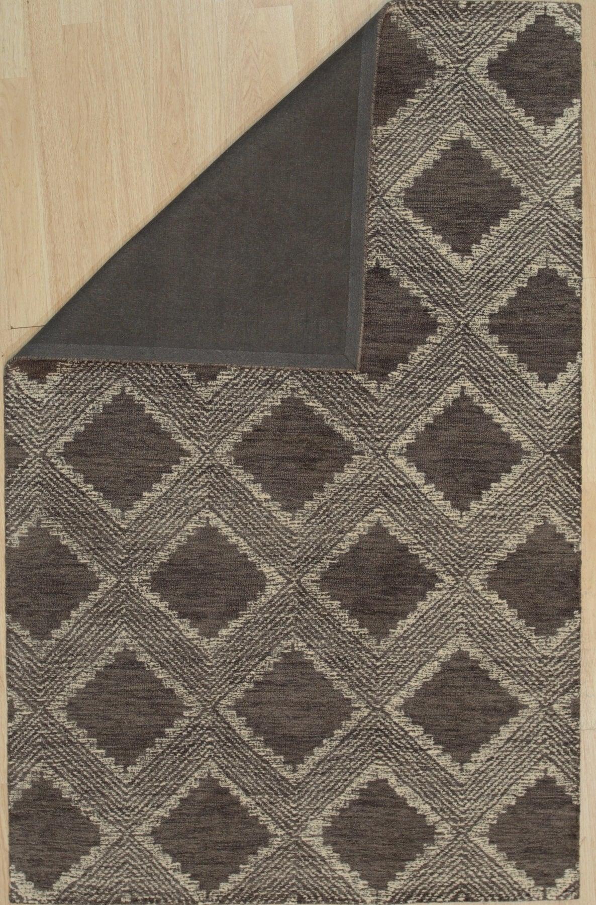 Xena Ava Charcoal Hand Tufted Wool Rug, a deep charcoal wool rug with a subtly textured hand-tufted design, enhancing a modern living room.