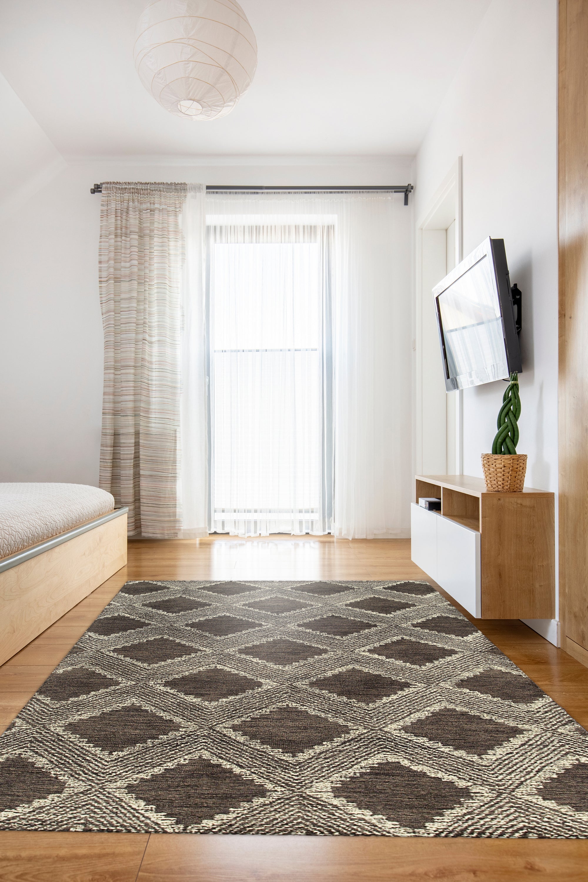 Xena Ava Charcoal Hand Tufted Wool Rug, a charcoal wool rug with subtle textured patterns, displayed in a bright, modern living space.