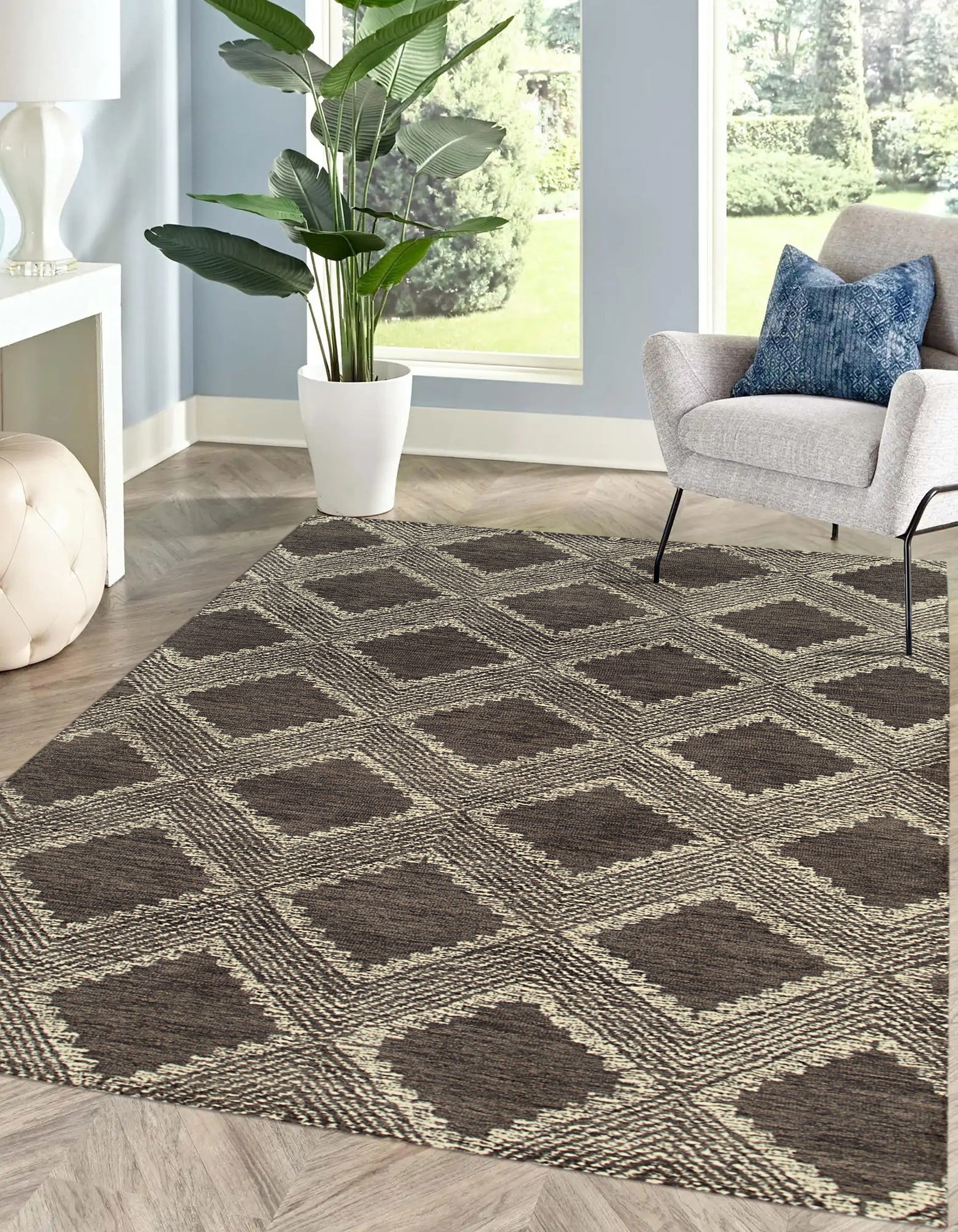 Xena Ava Charcoal Hand Tufted Wool Rug, a deep charcoal wool rug with subtle textural variations, partially visible in a warm, inviting living room setting.