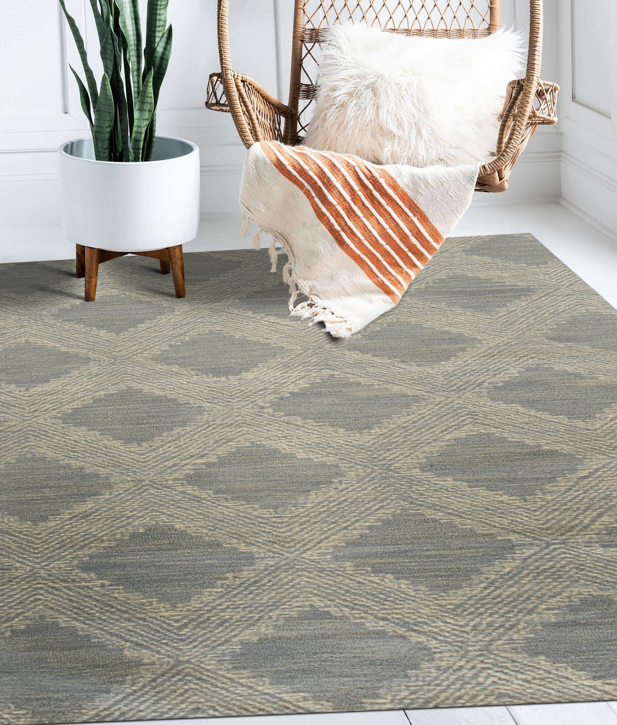 Chloe Quinn Light Blue Hand Tufted Wool Rug, light blue and wool rug with a subtle geometric pattern, seen in a bright, neutral living space with modern furniture.