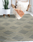Chloe Quinn Light Blue Hand Tufted Wool Rug, light blue and wool rug with a subtle geometric pattern, seen in a bright, neutral living space with modern furniture.