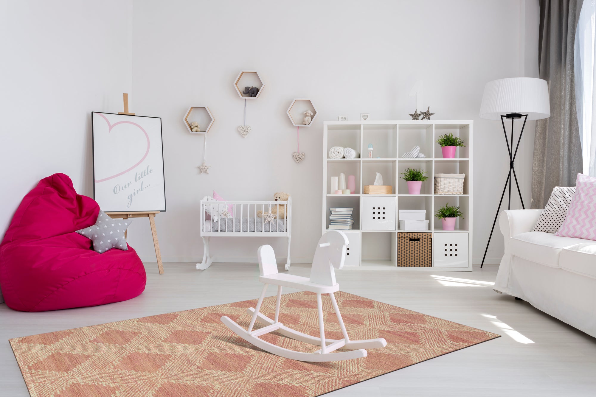 Unique Sloane Pink Hand Tufted Wool Rug, blush pink tones wash across a densely tufted wool texture, seen enhancing a light-filled room.