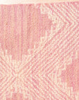 Unique Sloane Pink Hand Tufted Wool Rug, a soft blush-pink wool rug with a subtle geometric pattern, displayed in a bright, modern living space.