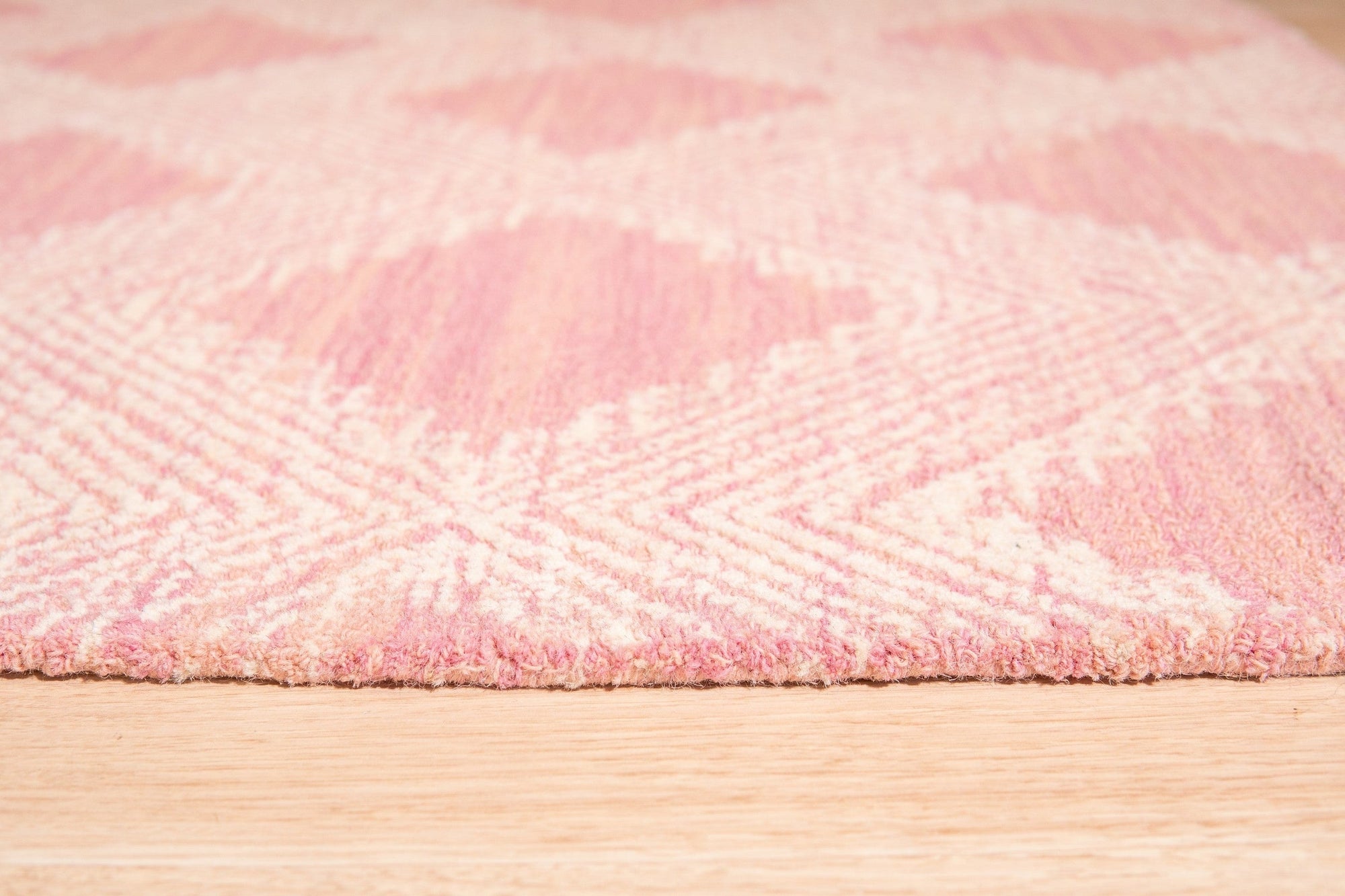 Since the image position is 7, here's the alt text:
 
 Unique Sloane Pink Hand Tufted Wool Rug, its soft pink hues and textured wool construction adding a touch of warmth and sophistication to a styled living space.