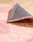 Unique Sloane Pink Hand Tufted Wool Rug, a soft pink wool rug with subtle geometric patterning, subtly textured and adding warmth to a bright living space.