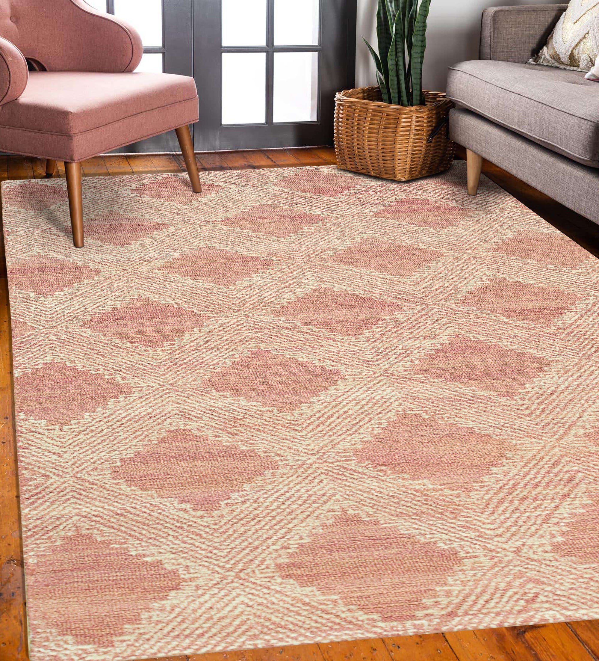 Unique Sloane Pink Hand Tufted Wool Rug, a soft blush and ivory wool rug with a subtle geometric pattern, displayed in a brightly lit living room setting.