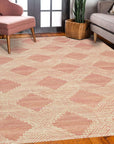 Unique Sloane Pink Hand Tufted Wool Rug, a soft blush and ivory wool rug with a subtle geometric pattern, displayed in a brightly lit living room setting.