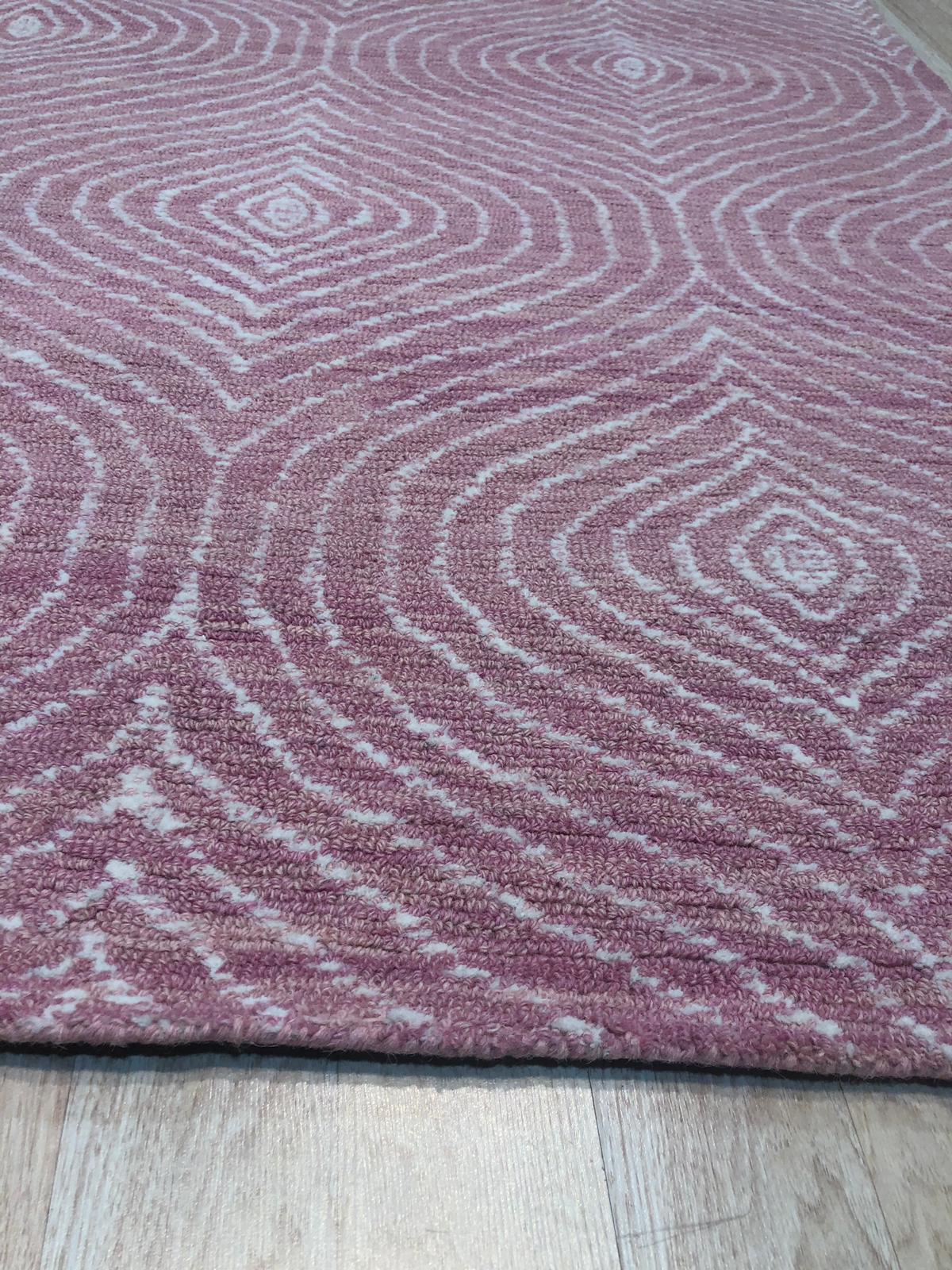 Talia Artistic Pink Hand Tufted Wool Rug, its vibrant pink hues and abstract patterns adding a splash of modern art to a bright, sunlit living space.