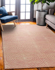 Talia Artistic Pink Hand Tufted Wool Rug, showcasing abstract swirls of blush, rose, and cream against a soft pink backdrop, lending a modern, textural warmth to a bright living space.