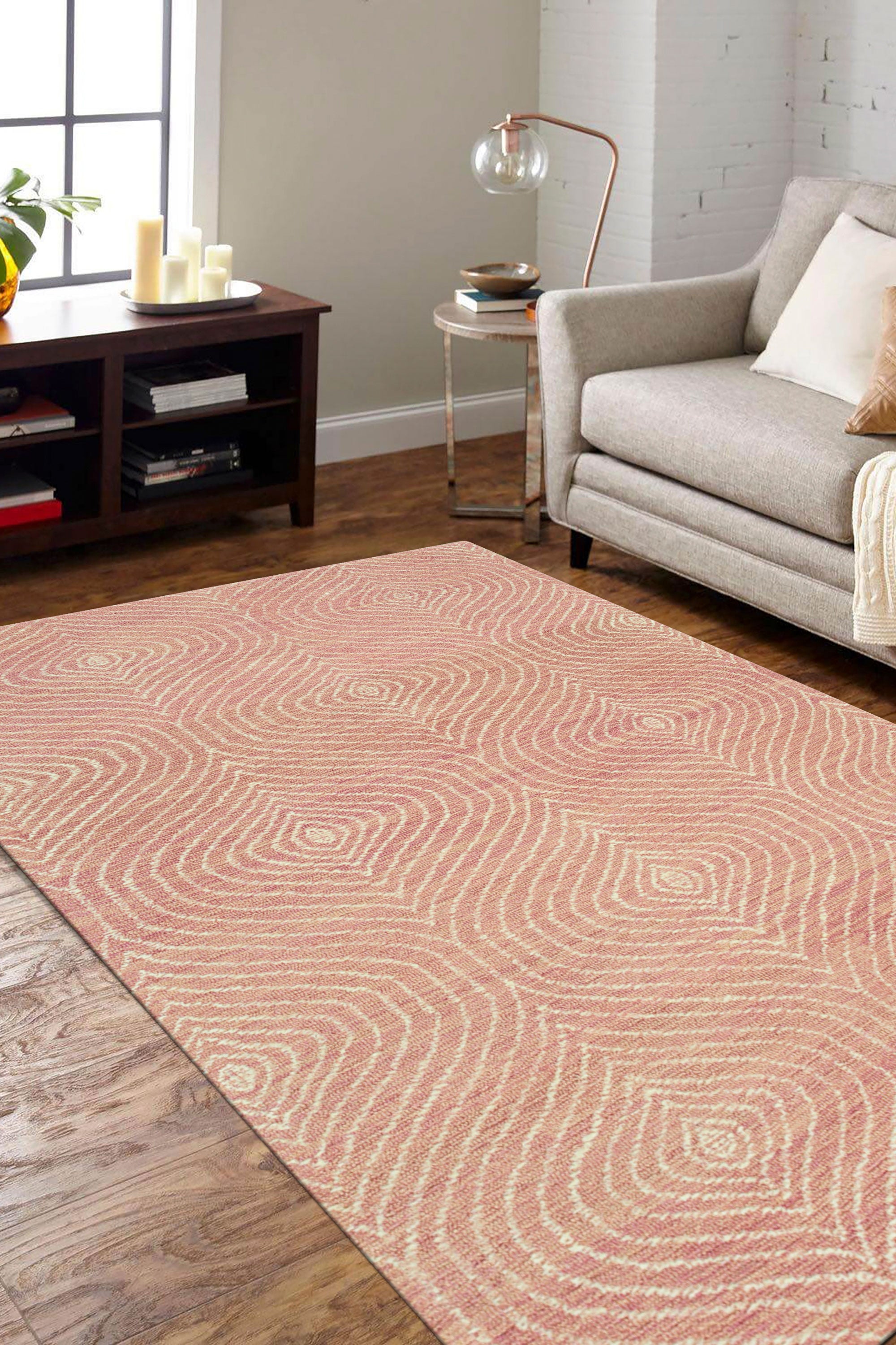 Talia Artistic Pink Hand Tufted Wool Rug, soft pink and cream hues swirling in an abstract design, covering a living room floor with plush texture and warmth.