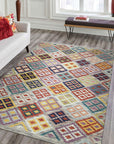 Nadia Kilim Multicolor Flatweave Wool Rug, blending vibrant hues in a geometric dance across a light wood floor, creating a warm and inviting living space.