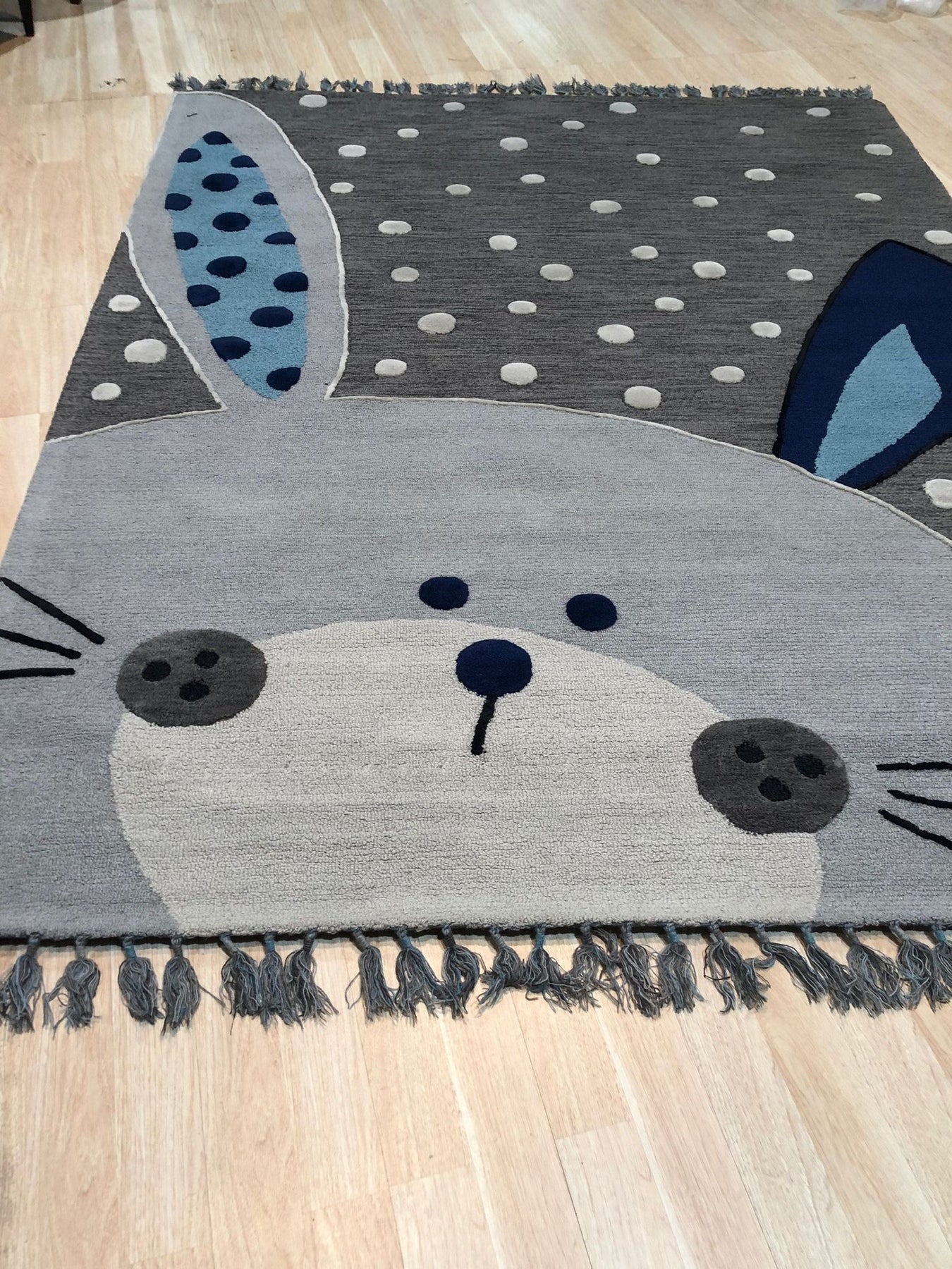 Harlow Bespoke Gray Hand Tufted Wool Rug, a subtle and luxurious gray wool rug with a contemporary abstract pattern, adds warmth and texture to a bright, modern living space.