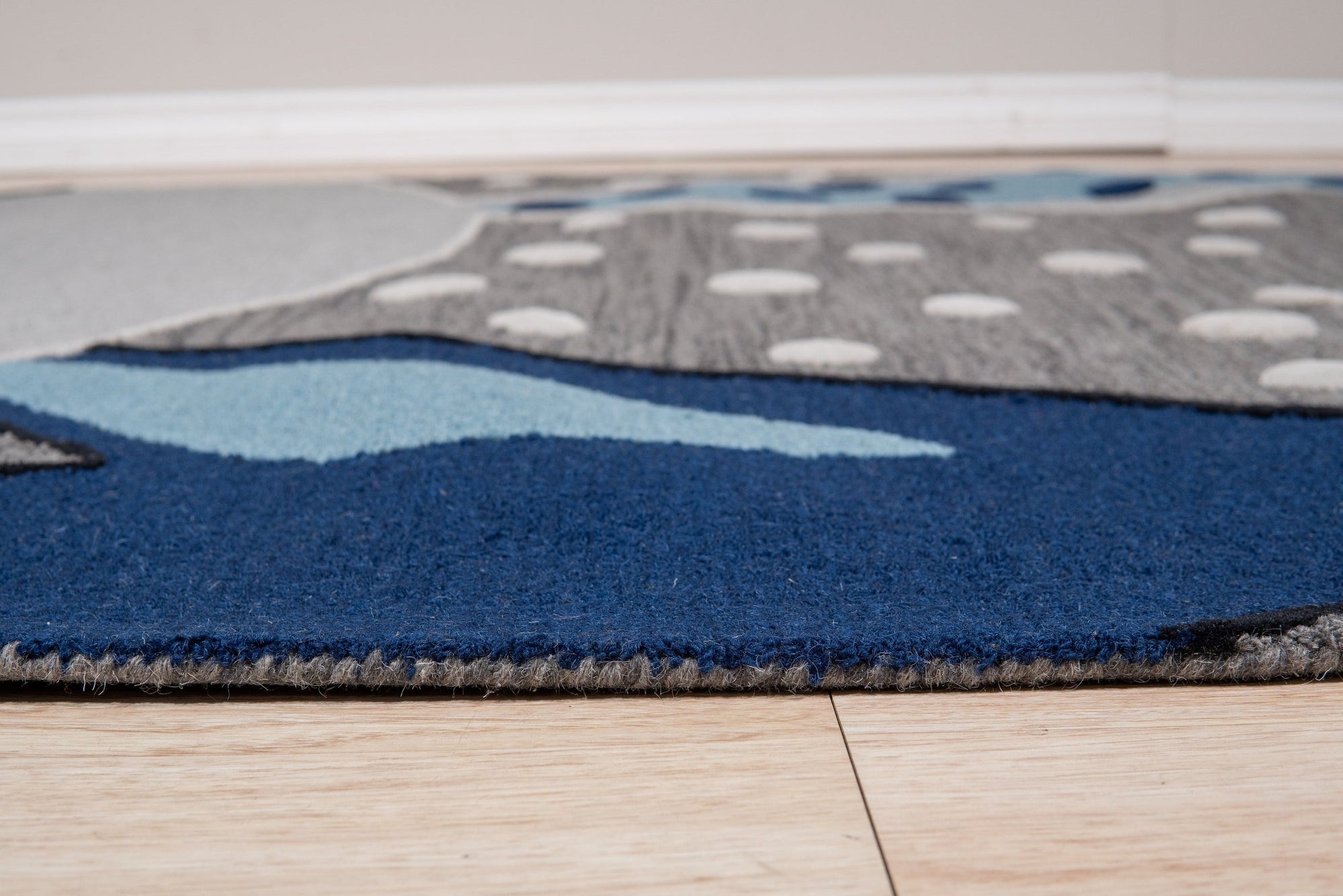 Harlow Bespoke Gray Hand Tufted Wool Rug, showcasing its subtle texture and tonal gray hues under warm, inviting light.