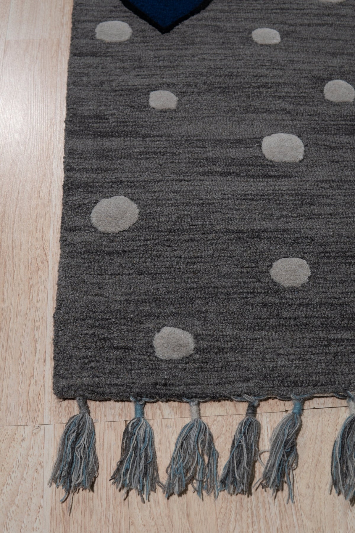 Harlow Bespoke Gray Hand Tufted Wool Rug, a plush gray wool rug with a subtle, textured design, seen in a bright, modern living room setting.
