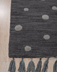 Harlow Bespoke Gray Hand Tufted Wool Rug, a plush gray wool rug with a subtle, textured design, seen in a bright, modern living room setting.