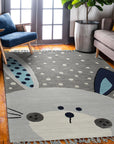 Harlow Bespoke Gray Hand Tufted Wool Rug, soft gray wool rug with subtle variations in texture and pile, partially visible under a sleek black side table.