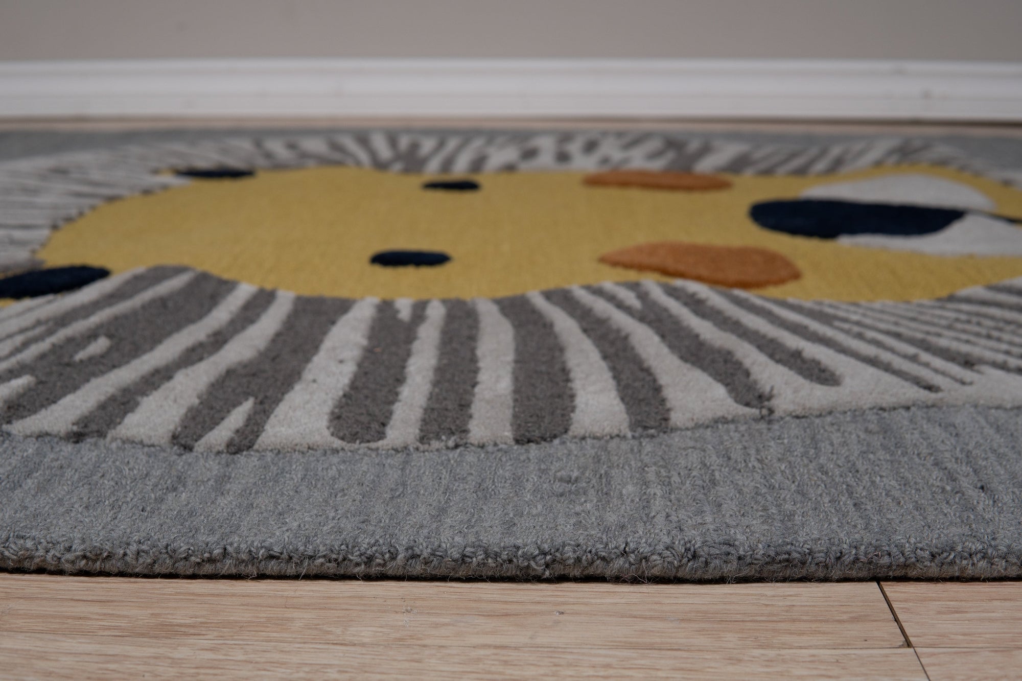 Lush Graceful Gray Hand Tufted Wool Rug displayed in a warmly lit living room setting. Gray hand-tufted wool rug anchors the space beneath a modern coffee table, showcasing its soft texture and graceful design.