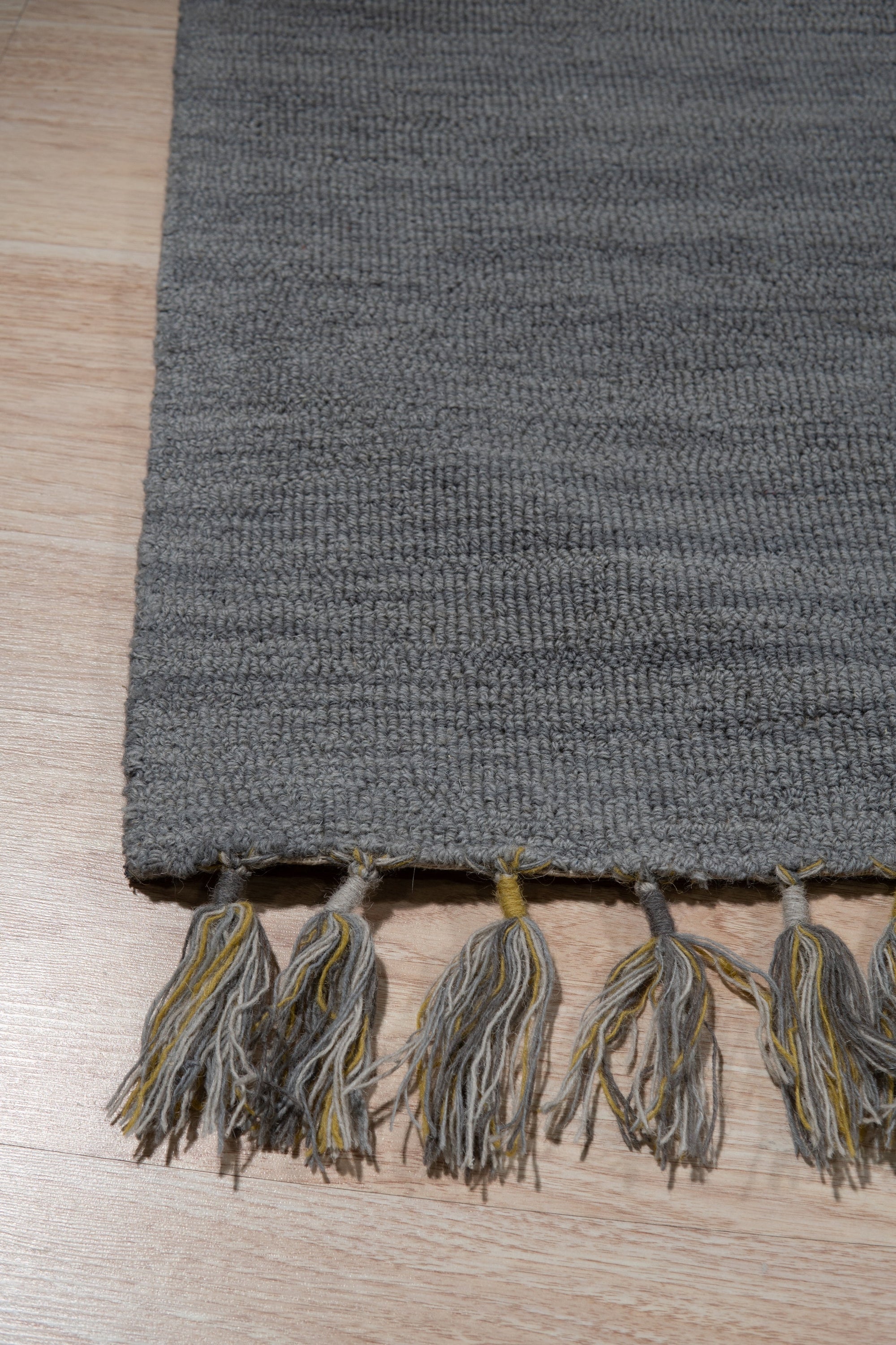 Lush Graceful Gray Hand Tufted Wool Rug, a subtle gray hand-tufted wool rug with a soft, plush pile, gracing a modern living space.