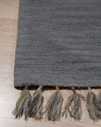 Lush Graceful Gray Hand Tufted Wool Rug, a subtle gray hand-tufted wool rug with a soft, plush pile, gracing a modern living space.