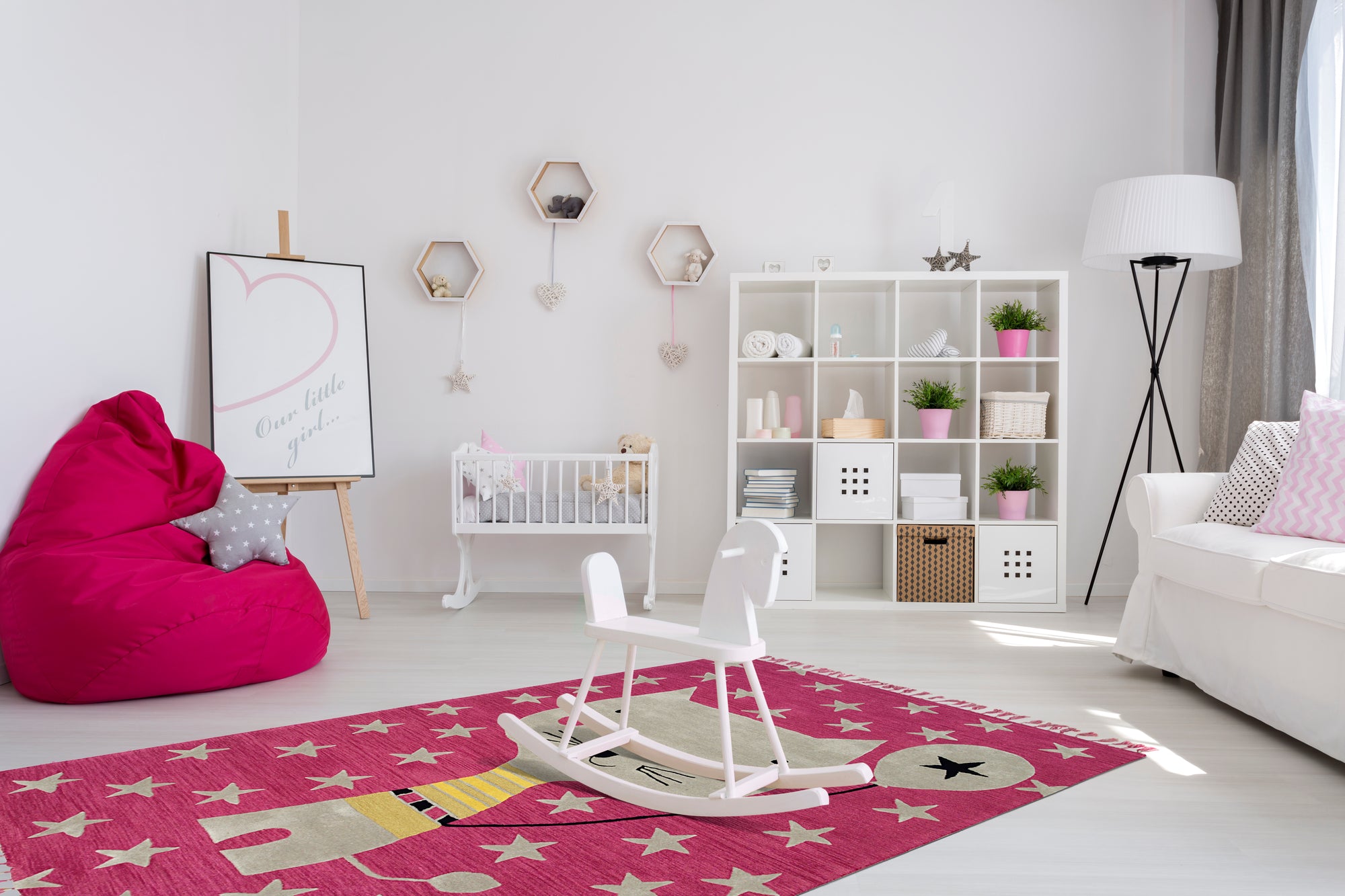 Iris Laine Pink Hand Tufted Wool Rug, a plush and vibrant rug featuring a delicate floral design in soft pink hues, lending a touch of elegant warmth to a bright living space.