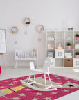 Iris Laine Pink Hand Tufted Wool Rug, a plush and vibrant rug featuring a delicate floral design in soft pink hues, lending a touch of elegant warmth to a bright living space.