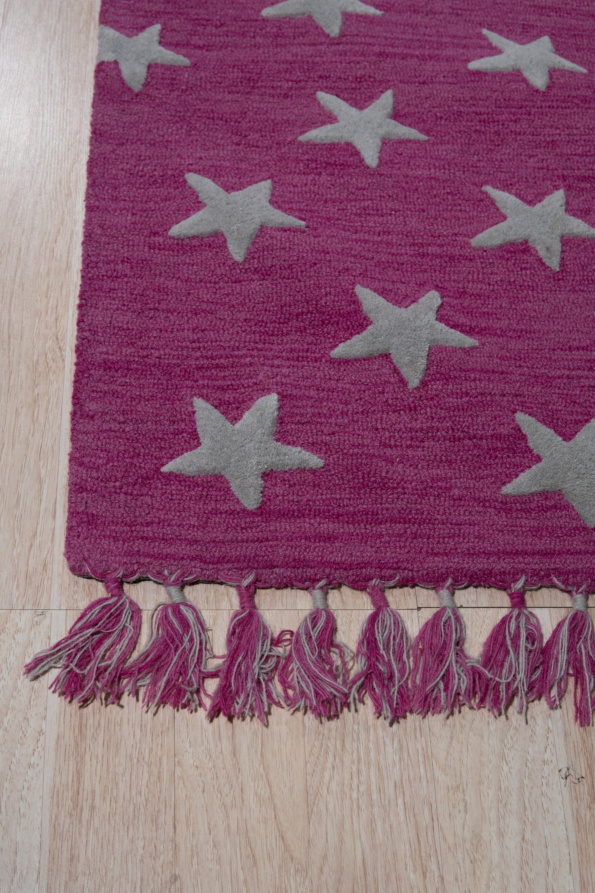Iris Laine Pink Hand Tufted Wool Rug in a bright, inviting living room. The rug's plush, hand-tufted wool texture and soft pink hue ground the space, creating a cozy and stylish atmosphere.