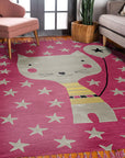 Iris Laine Pink Hand Tufted Wool Rug, softly glowing on a light hardwood floor, its hand-tufted wool offering a plush texture and a gentle wash of pink across its subtle design, bathed in warm, natural light.