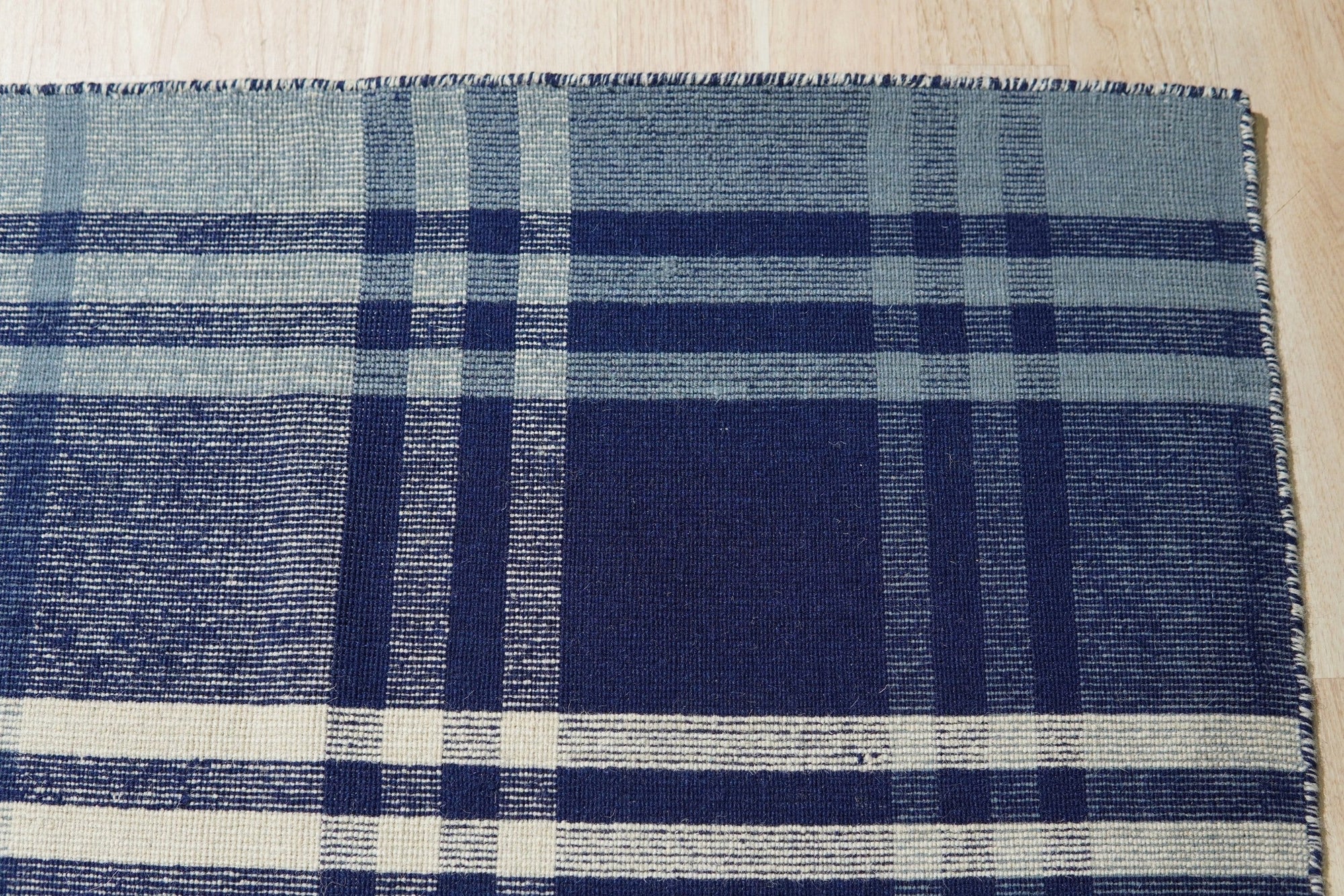 Sophisticated Elegant Blue Flatweave Wool Rug, its cool blue tones and flatweave construction anchoring a brightly lit living room.
