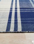 Sophisticated Elegant Blue Flatweave Wool Rug, its cool blues and elegant weave grounding a bright, airy living space with modern furniture.
