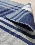 Sophisticated Elegant Blue Flatweave Wool Rug, a calming expanse of blue woven wool, rests on light hardwood floors, its flatweave construction lending a subtle texture to the room.