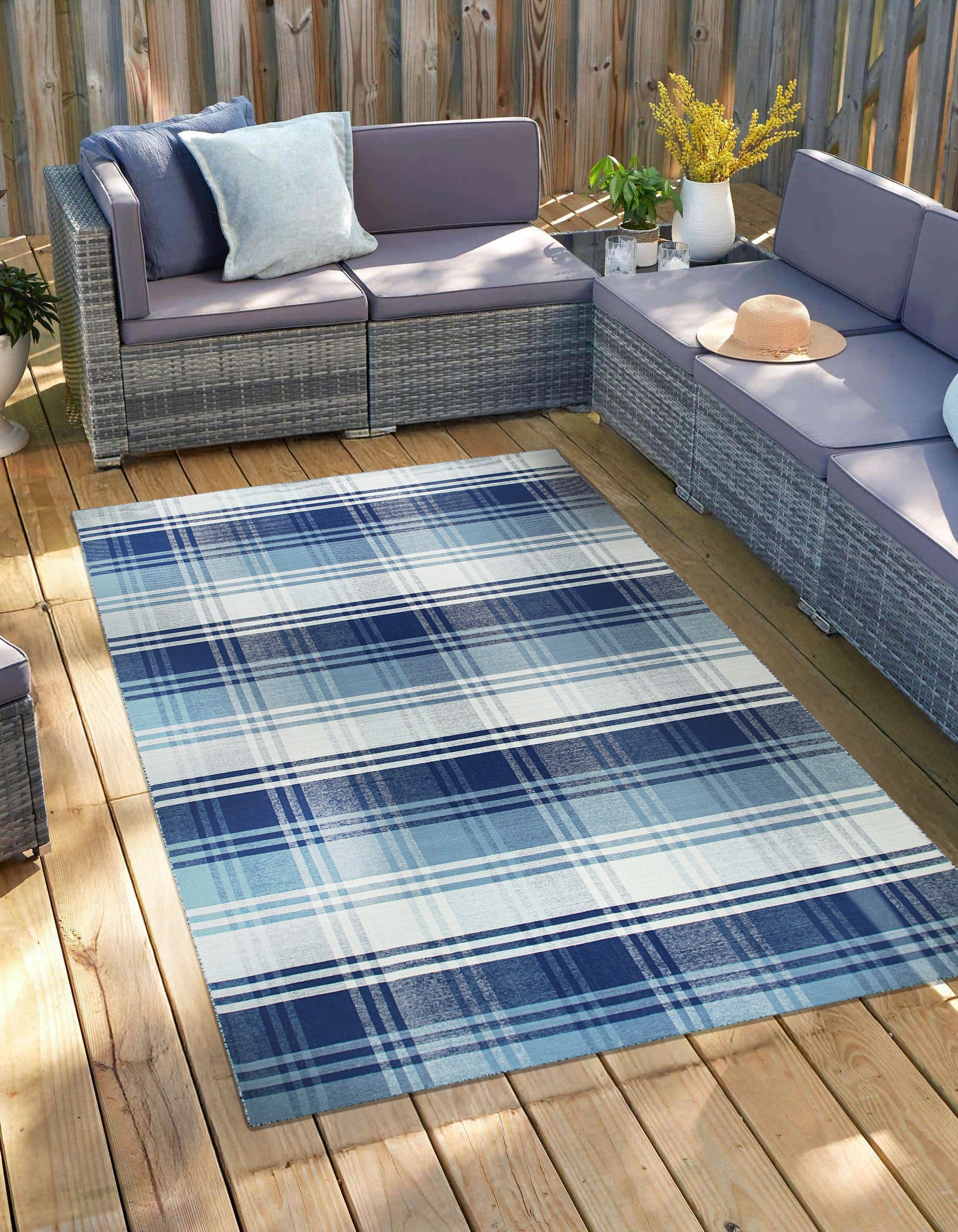 Sophisticated Elegant Blue Flatweave Wool Rug, a cool-toned blue wool flatweave, lies gracefully on a polished wooden floor, hinting at a modern living room setting.