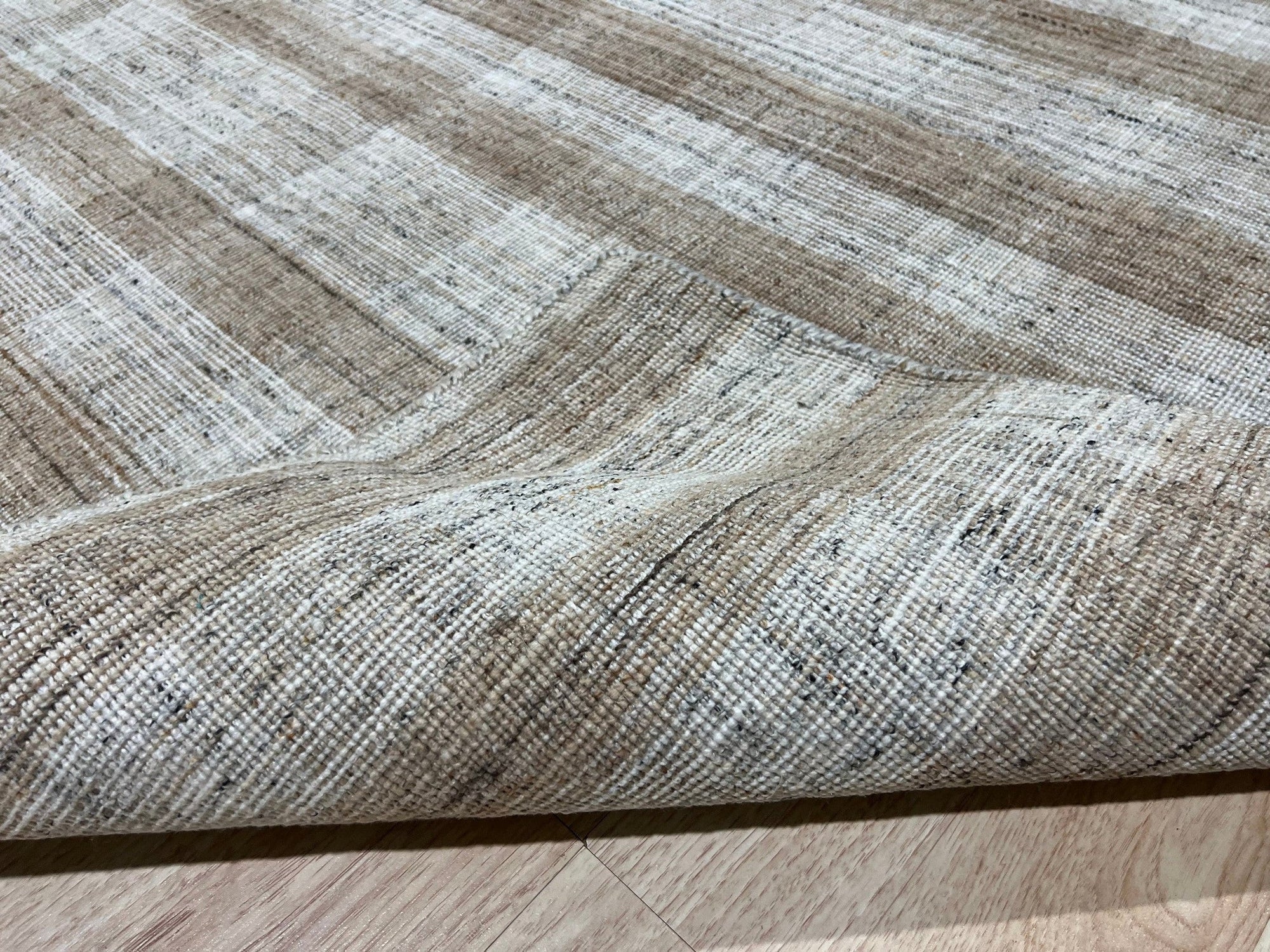 Serene Chloe Beige Flatweave Wool Rug, warm neutral tones and subtle woven texture anchoring a living room space with natural light.
