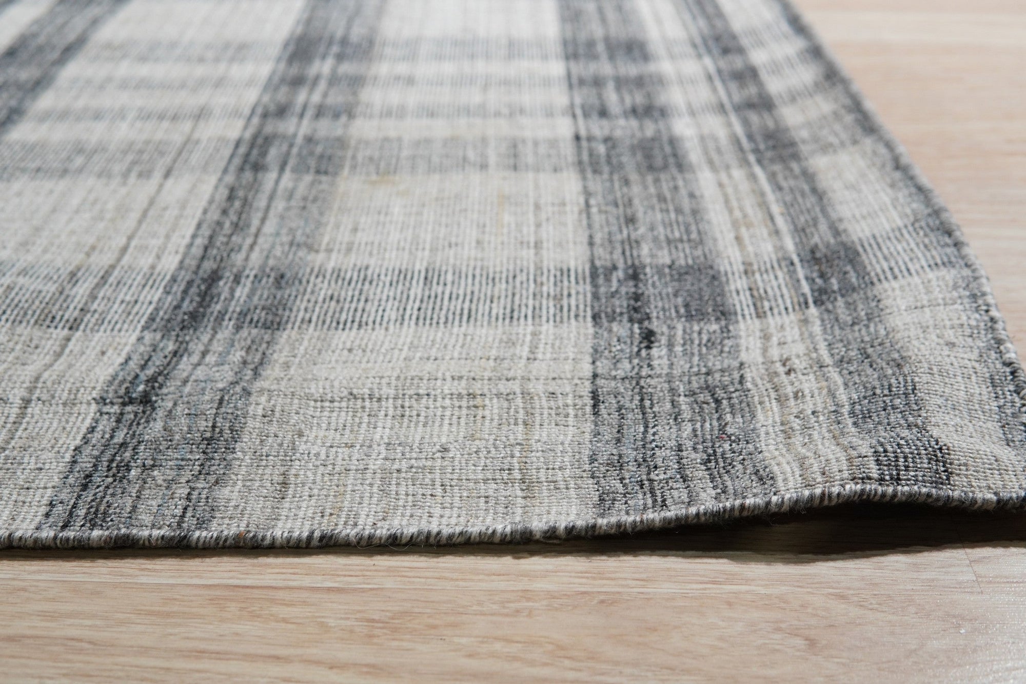 Jasmine Stylish Gray Flatweave Wool Rug, a cool gray wool flatweave adding subtle texture and modern elegance to a bright, minimalist living space.