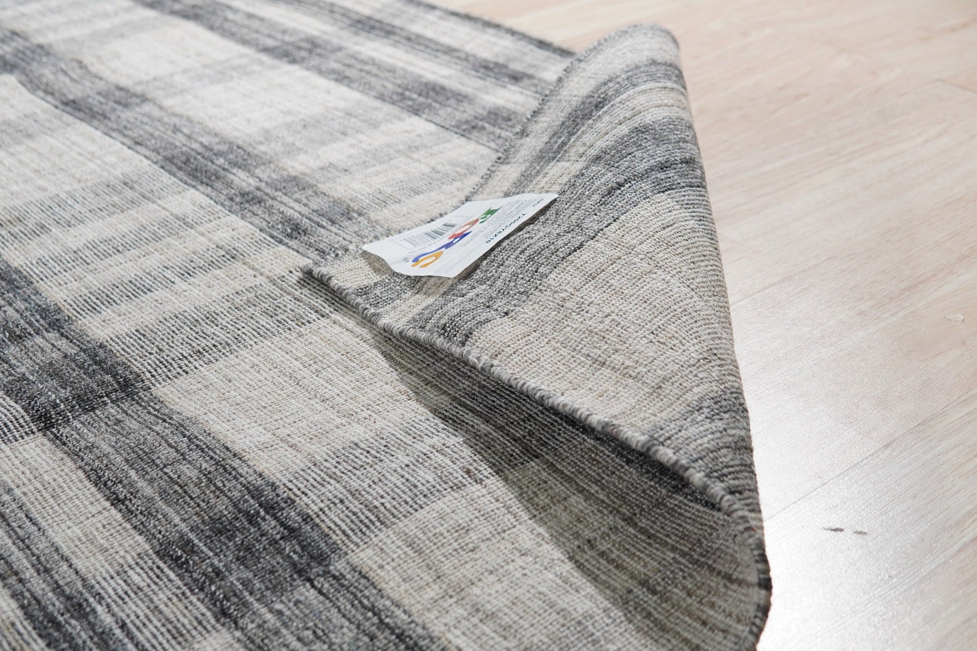 Jasmine Stylish Gray Flatweave Wool Rug, bringing subtle texture and a modern gray palette to a bright living space. Flatweave construction showcases its wool fibers and minimalist design.