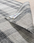 Jasmine Stylish Gray Flatweave Wool Rug, bringing subtle texture and a modern gray palette to a bright living space. Flatweave construction showcases its wool fibers and minimalist design.