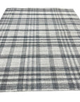 Jasmine Stylish Gray Flatweave Wool Rug, a textured expanse of gray wool with a subtle, modern pattern, displayed within a bright, airy living space.