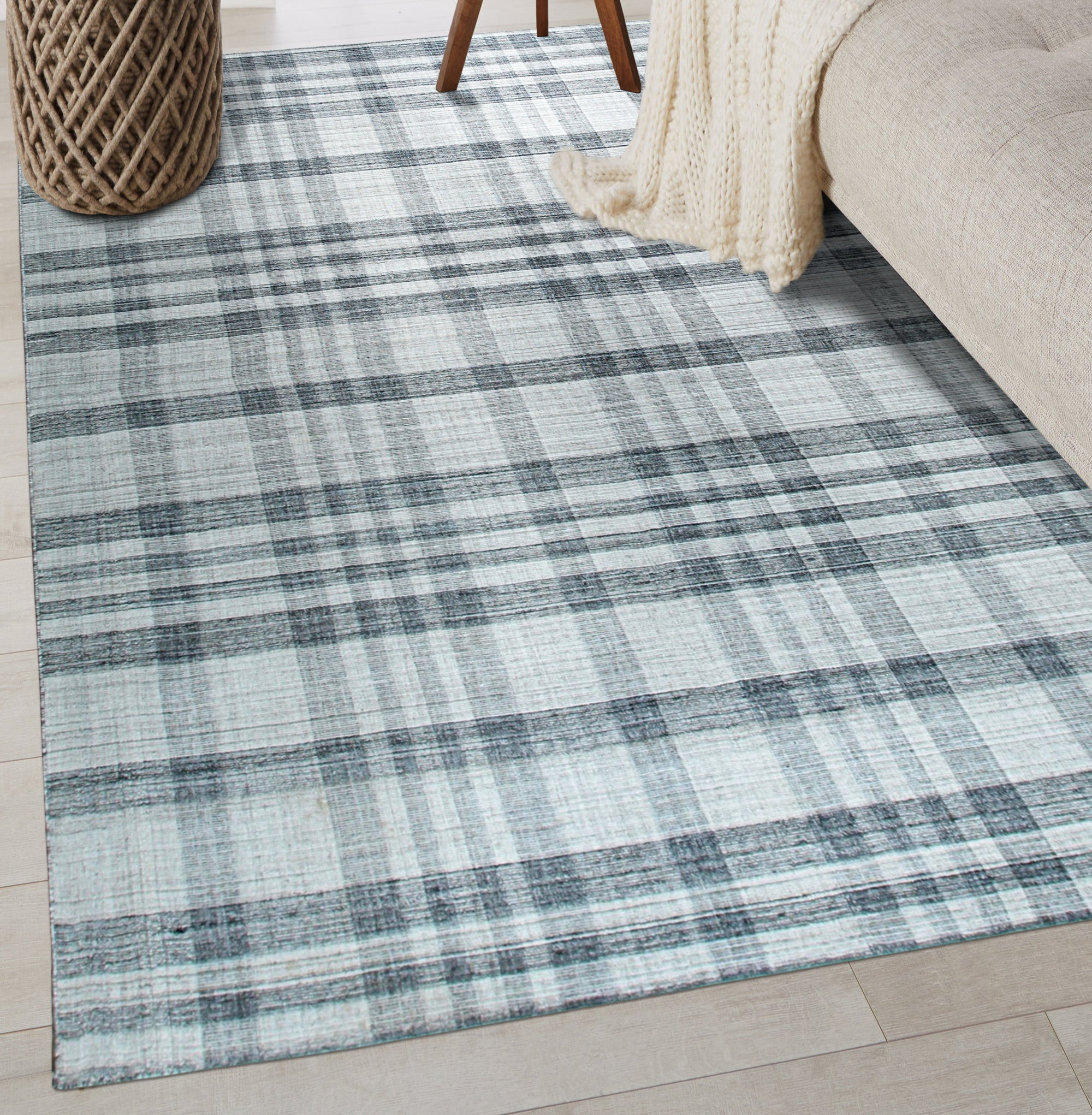 Jasmine Stylish Gray Flatweave Wool Rug graces a warmly lit living room; its subtle gray tones and flatweave construction anchoring a cozy seating arrangement with a mid-century modern sofa and minimalist decor.