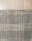 Classic Radiant Gray Flatweave Wool Rug in a bright living room; soft light illuminates the rug's subtle gray tones and flatweave texture beneath a modern coffee table.