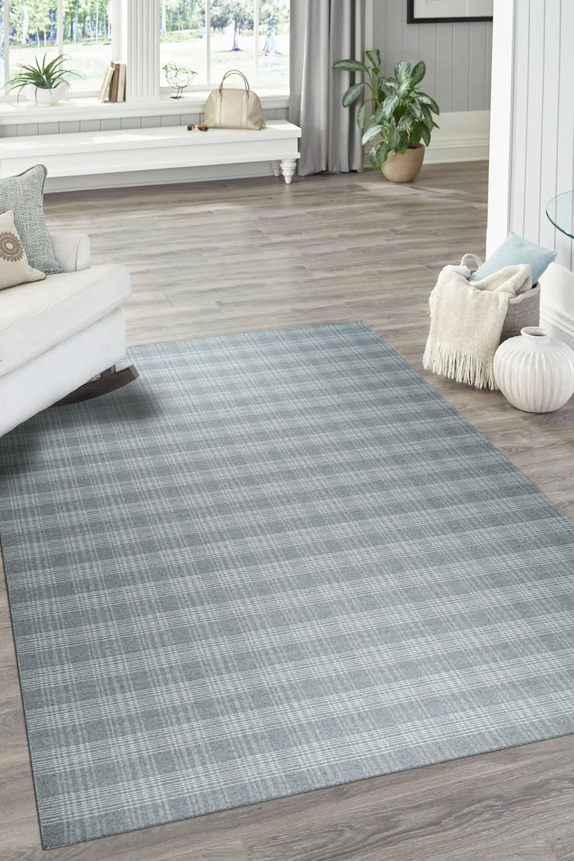 Classic Radiant Gray Flatweave Wool Rug, its soft gray tones and flatweave construction lending sophisticated texture to a modern living space with a cream colored sofa and natural wood furniture.