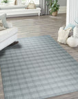 Classic Radiant Gray Flatweave Wool Rug, its soft gray tones and flatweave construction lending sophisticated texture to a modern living space with a cream colored sofa and natural wood furniture.