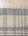 Handcrafted Vibrant Gray Flatweave Wool Rug displayed on a light wooden floor, its gray tones subtly shifting with the light, a testament to its flatweave wool construction.