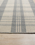 Handcrafted Vibrant Gray Flatweave Wool Rug, woven in a flatweave style, dominates a modern living space, its subtle gray tones grounding the room beneath minimalist furniture.